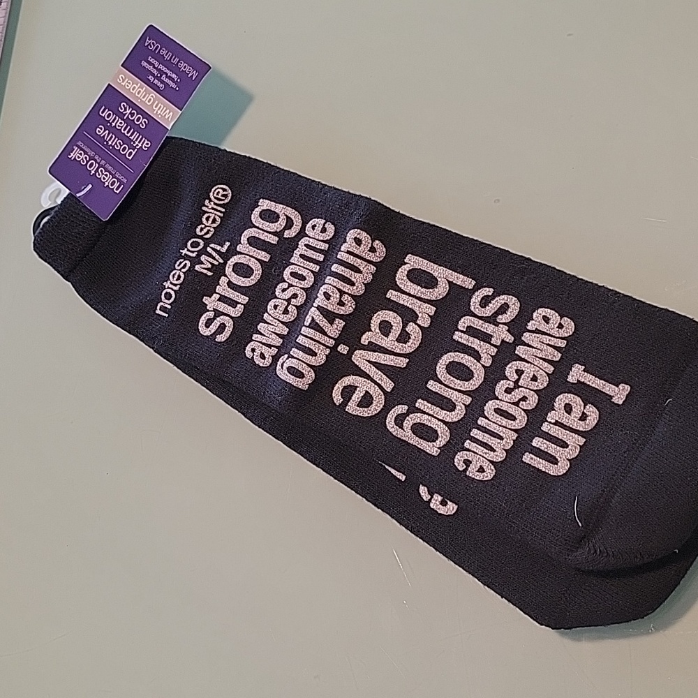 strong.. awesome... black socks with white words. High quality gripper socks.